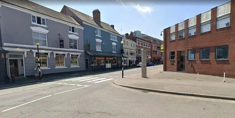 Warstone Lane in Birmingham's Jewellery Quarter, with the red brick DOLLHOUSE studio building on the corner of Spencer Street